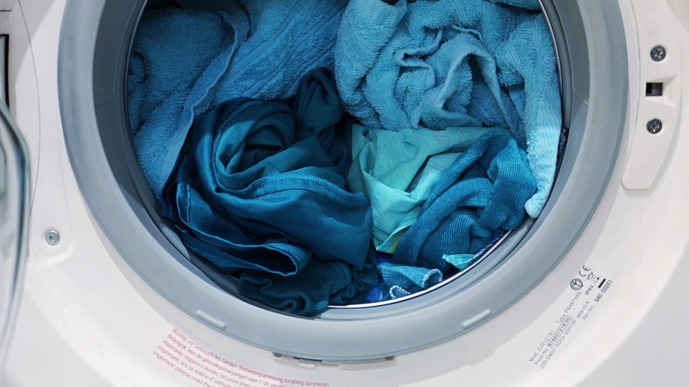 Full washing machine with blue linens